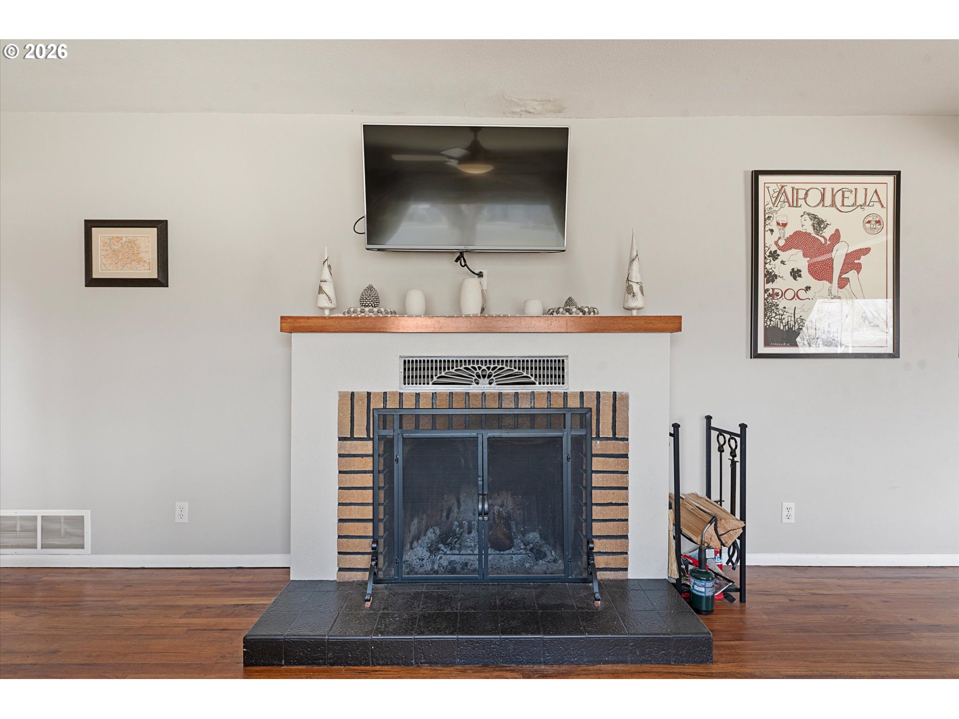 2975 North 3rd Street Baker City, OR 97814 - Photo 7 of 48 a living room with a fireplace and a flat screen tv