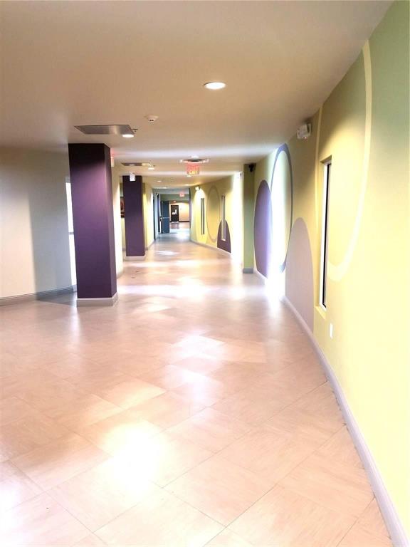 1100 West Trinity Mills Road, Unit 3039 Carrollton, TX 75006 - Photo 16 of 25 a view of a hallway with wooden shelves