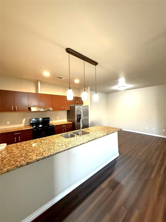 1100 West Trinity Mills Road, Unit 3039 Carrollton, TX 75006 - Photo 2 of 25 a large kitchen with a large counter top a sink and cabinets