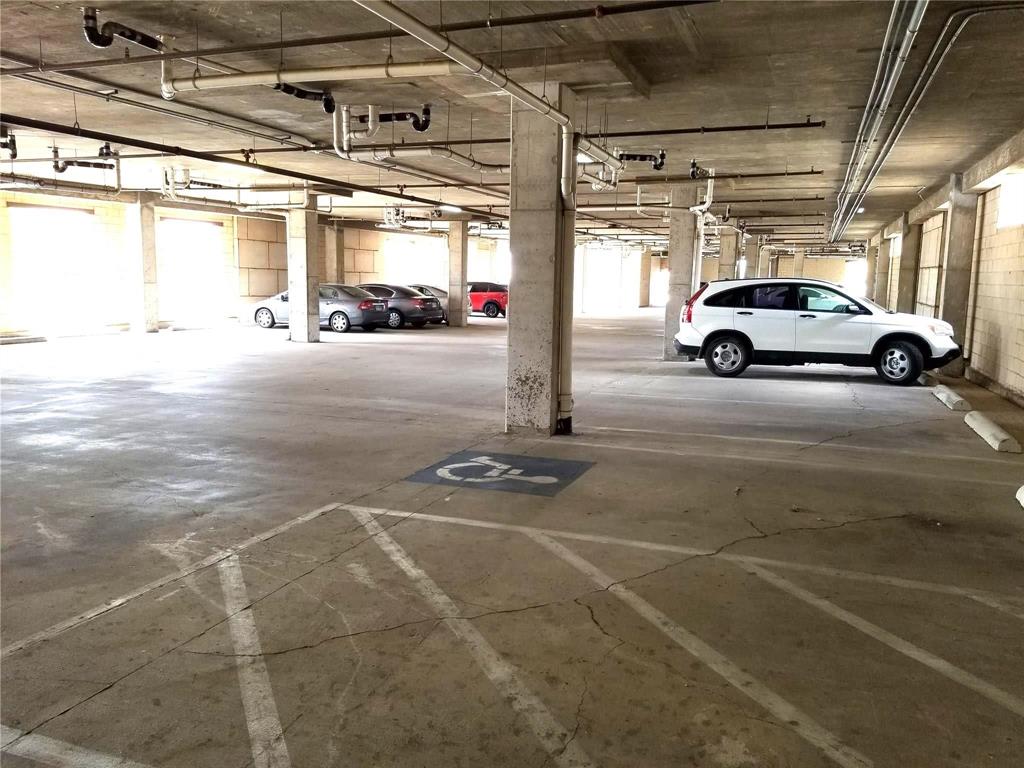 1100 West Trinity Mills Road, Unit 3039 Carrollton, TX 75006 - Photo 23 of 25 a view of parking garage with cars parked