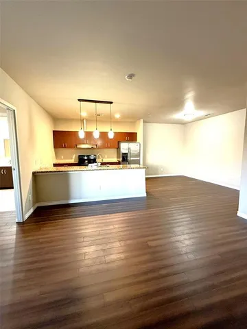 a view of an empty room with a windows and fireplace