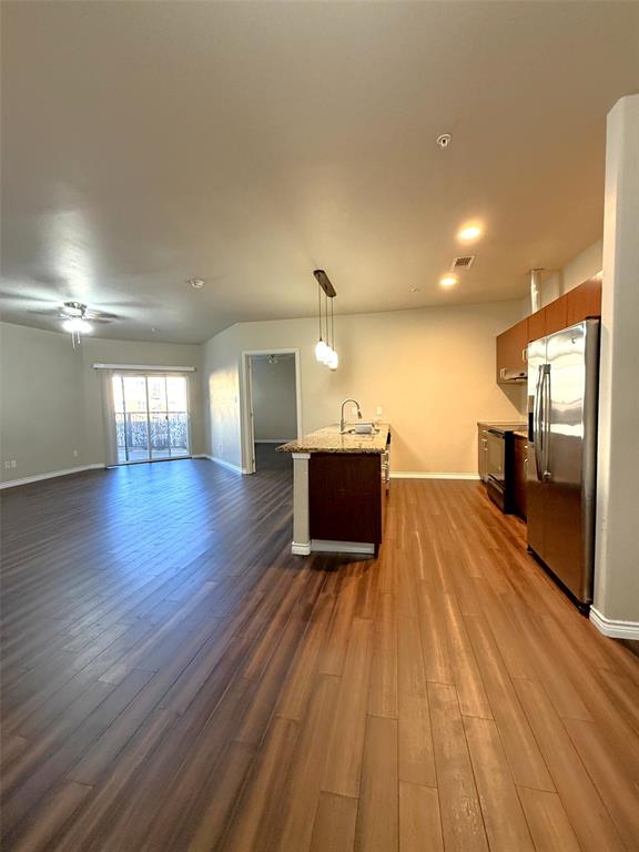 1100 West Trinity Mills Road, Unit 3039 Carrollton, TX 75006 - Photo 25 of 25 a view of a big room with wooden floor and windows