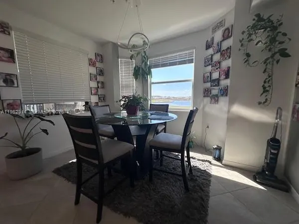 a dining room with furniture and window