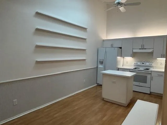 a kitchen with a sink cabinets and appliances