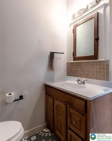 a bathroom with a sink toilet and mirror