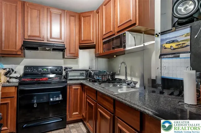 a kitchen with stainless steel appliances granite countertop a stove and a sink
