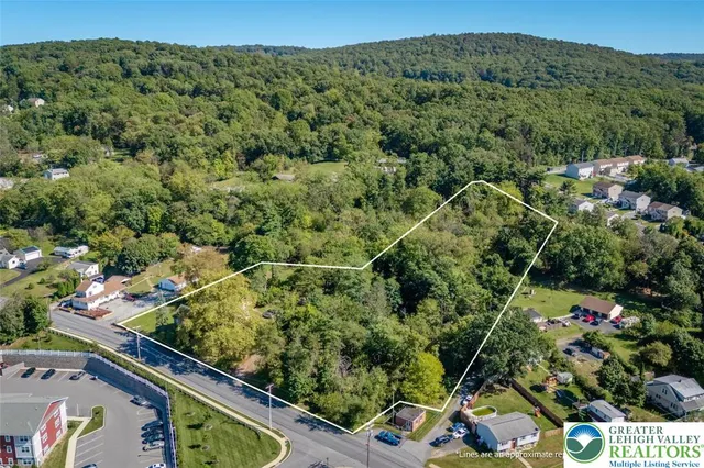 an aerial view of a forest with houses