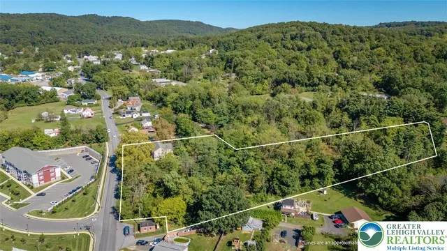 an aerial view of residential houses with outdoor space