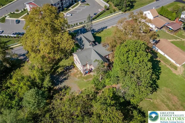 an aerial view of a house with a yard