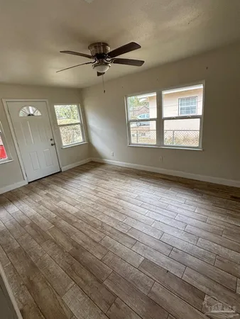 wooden floor in an empty room with a window
