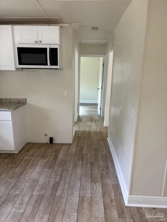a view of a kitchen from the hallway