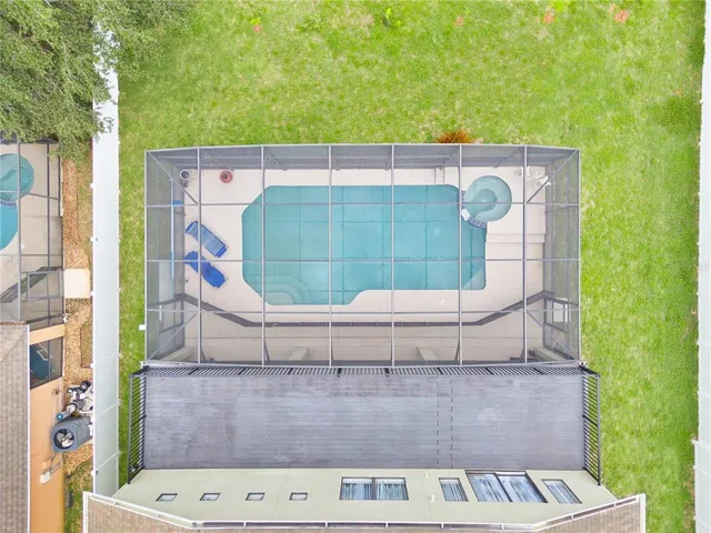 an aerial view of a house with a garden and swimming pool