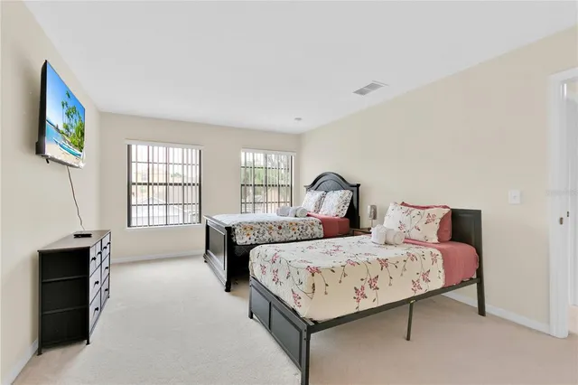 a bedroom with a bed and a painting on the wall