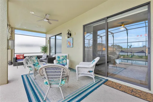 a living room with furniture and a floor to ceiling window