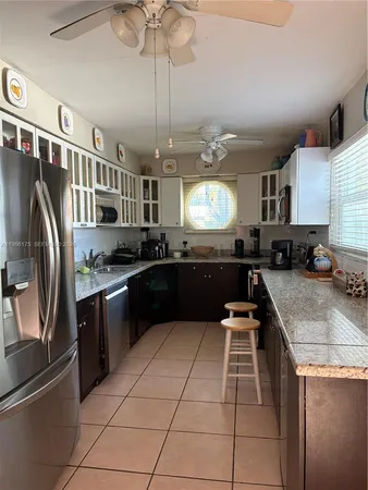 a kitchen with stainless steel appliances granite countertop a sink and a stove