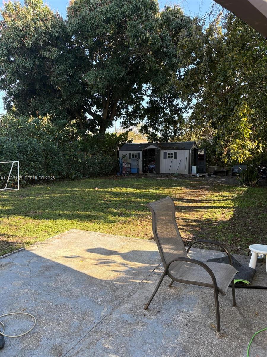 1758 Southwest 18th Street Miami, FL 33145 - Photo 10 of 15 a view of a swimming pool with lawn chairs under an umbrella