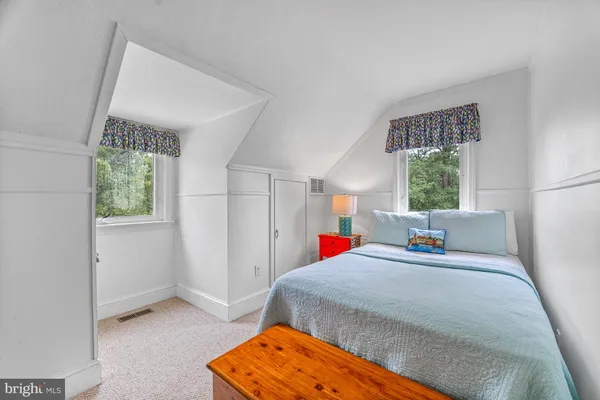 a bed room with a bed window and a lamp