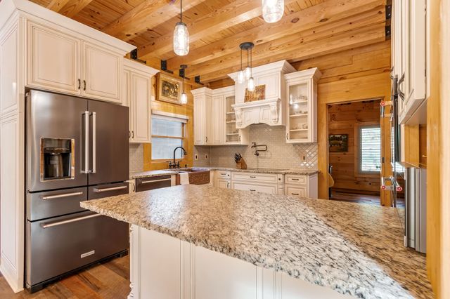 a bathroom with a granite countertop sink mirror and a bathtub