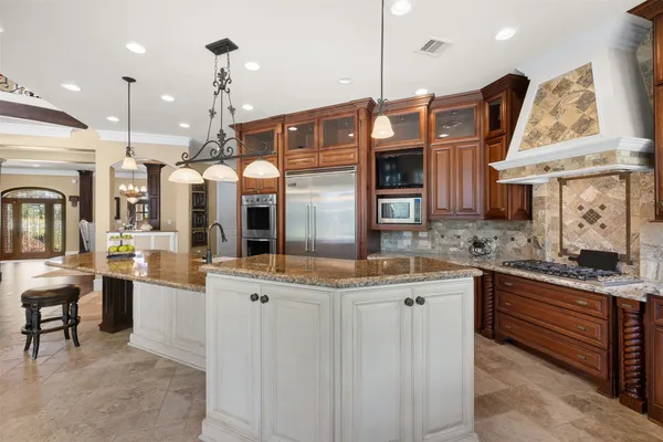 a kitchen with stainless steel appliances granite countertop a stove and cabinets