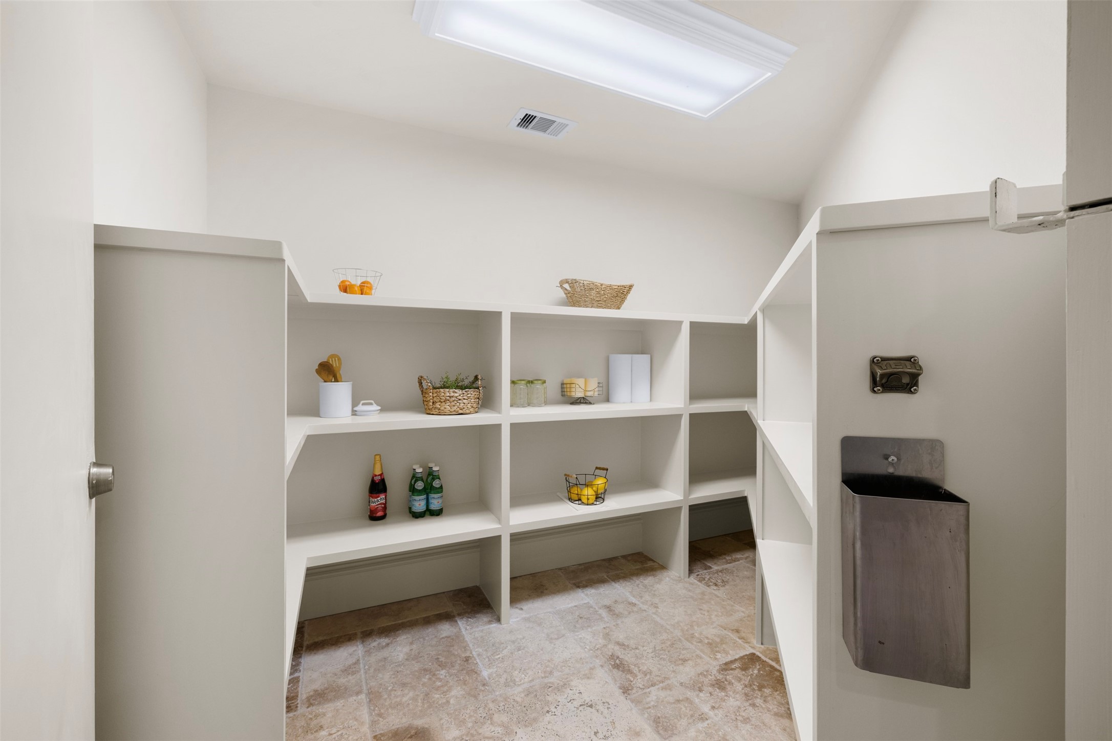 29500 Skymac Ranch Road Hempstead, TX 77445 - Photo 15 of 50 The walk-in pantry is as functional as it is unforgettable, featuring extensive shelving alongside a dramatic steel door with bold hinges—creating a concealed, vault-style space that doubles as a safe escape.