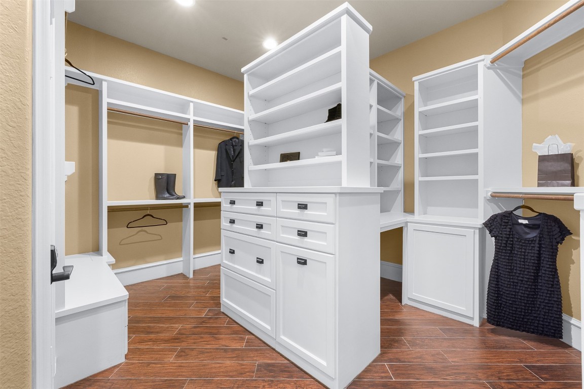 29500 Skymac Ranch Road Hempstead, TX 77445 - Photo 19 of 50 The primary closet is thoughtfully designed with abundant built-in drawers and shelving, offering both beauty and organization, while a discreet secondary room at the rear, houses security and home systems for added functionality.