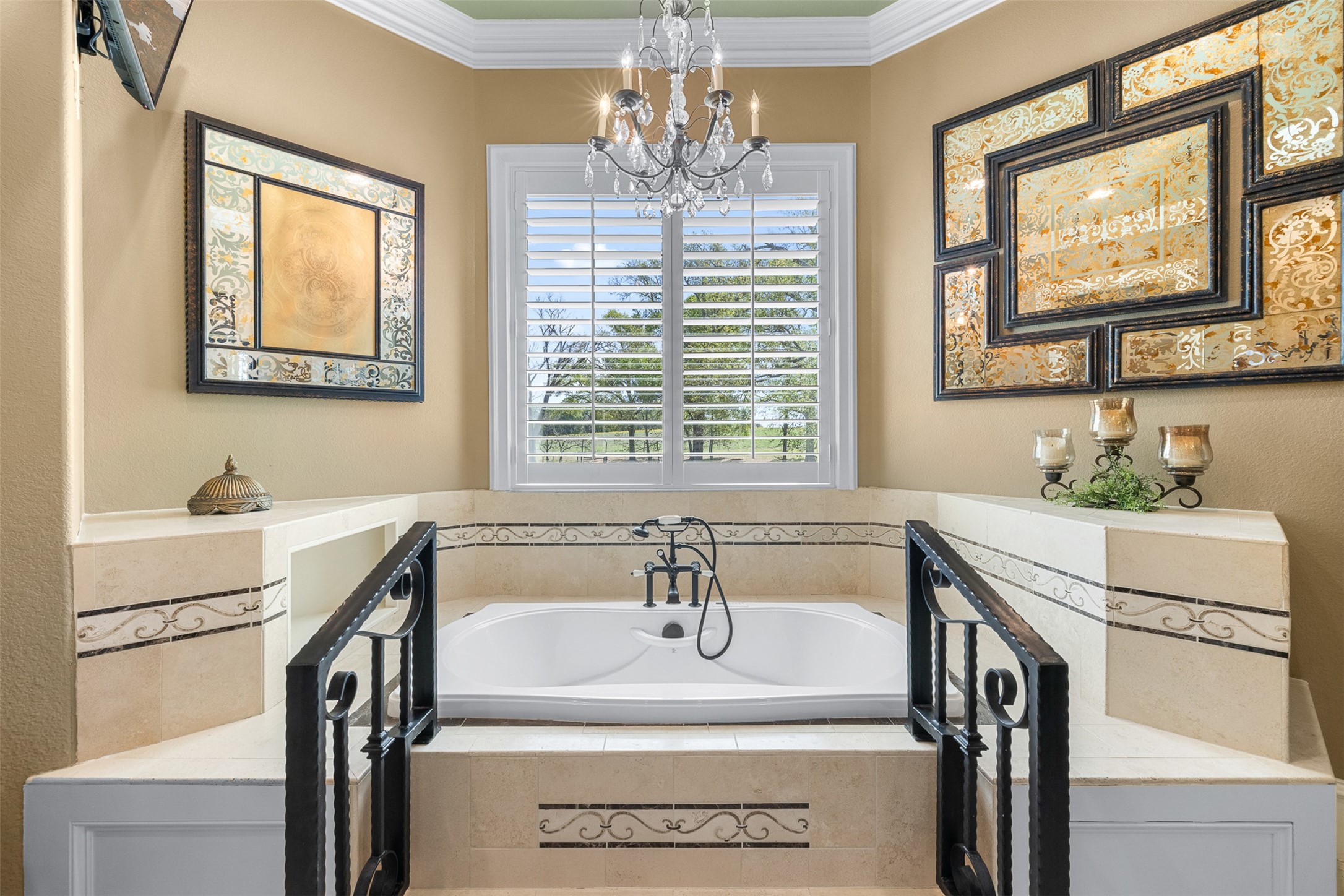 29500 Skymac Ranch Road Hempstead, TX 77445 - Photo 20 of 50 A statement Jacuzzi tub is set atop a tiered platform with decorative wrought iron railings, framed by a window capturing sweeping views of the acreage—offering a true retreat.