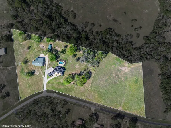 an aerial view of a residential houses with outdoor space