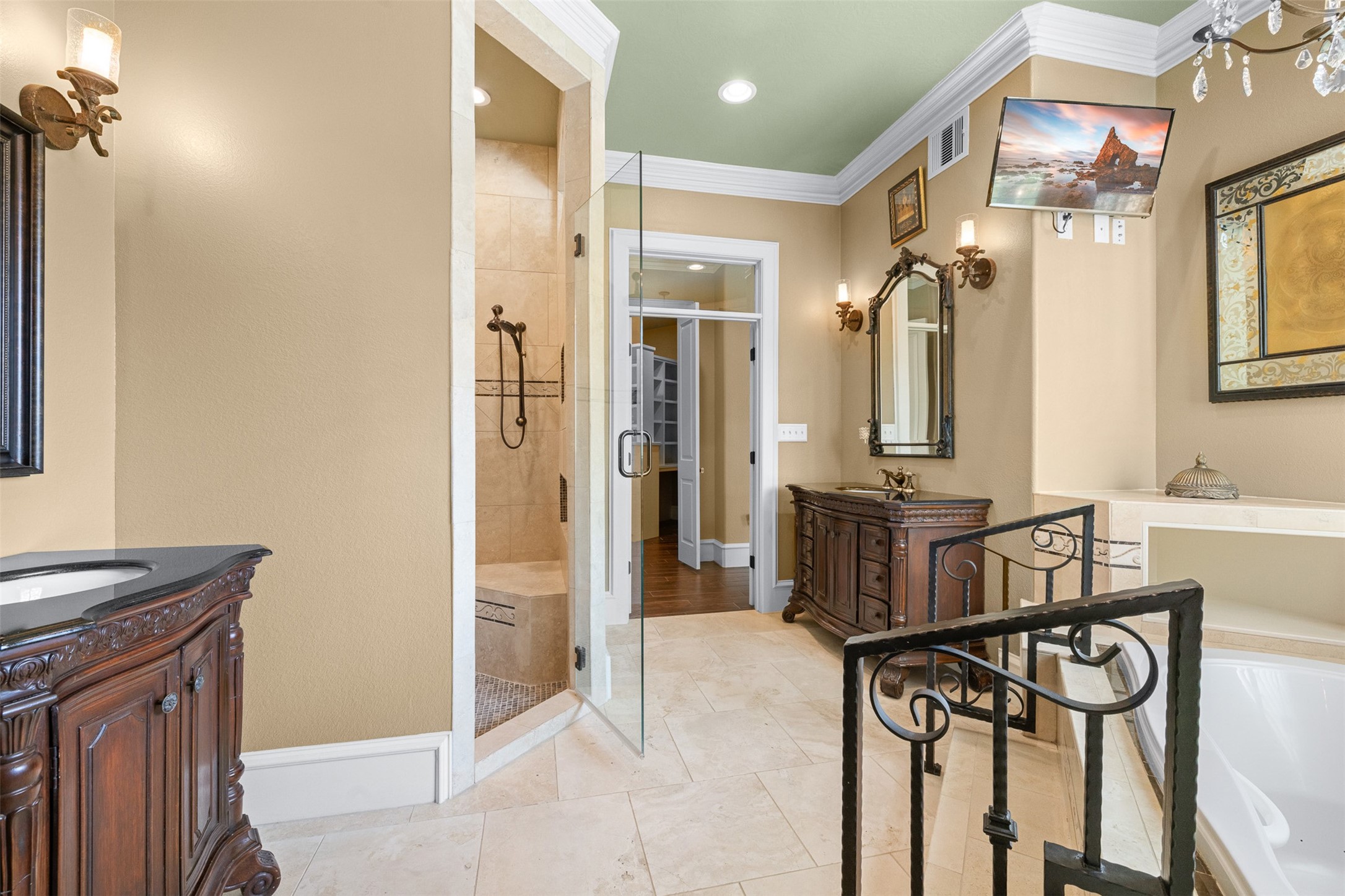 29500 Skymac Ranch Road Hempstead, TX 77445 - Photo 22 of 50 Beautifully detailed vanities bring a furniture-like feel, while the glass walk-in shower and integrated television create a space designed for both relaxation and everyday ease, finished with elegant crystal touches.