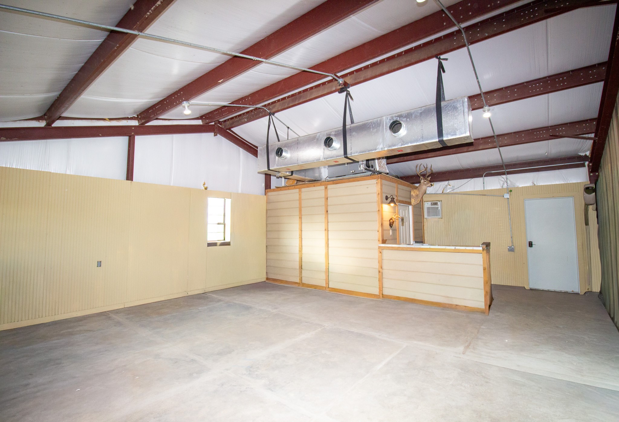 29500 Skymac Ranch Road Hempstead, TX 77445 - Photo 48 of 50 Showcasing the area adjacent to the shop’s full bath, this view also highlights the insulated structure, designed for improved usability and year-round comfort.