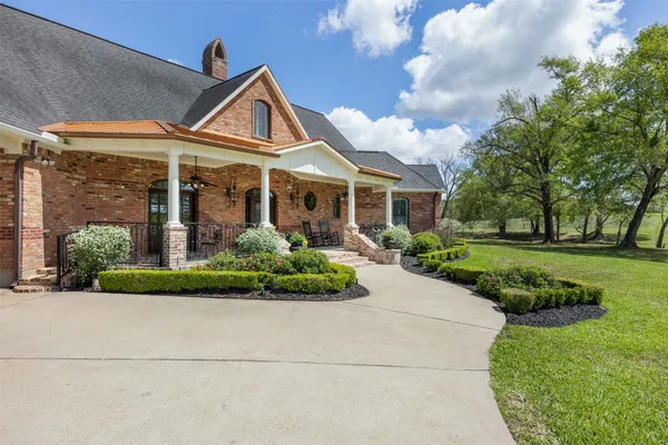 a front view of a house with garden