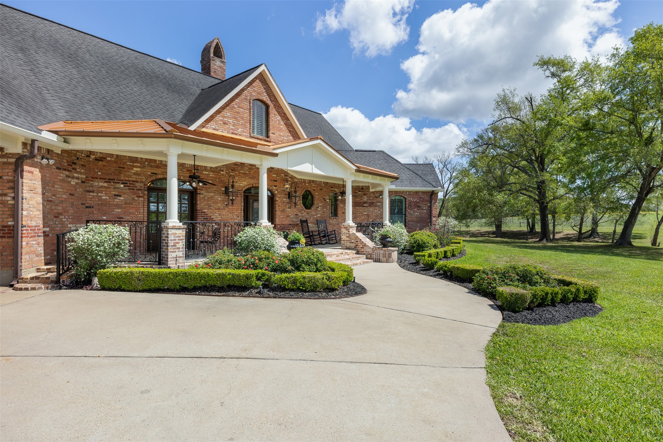 29500 Skymac Ranch Road Hempstead, TX 77445 - Photo 5 of 50 Quiet mornings start here—coffee on the covered porch with peaceful views of the grounds.