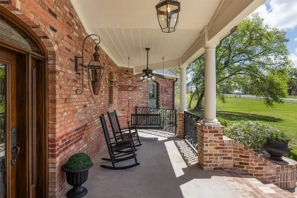 a view of a porch with chairs and backyard