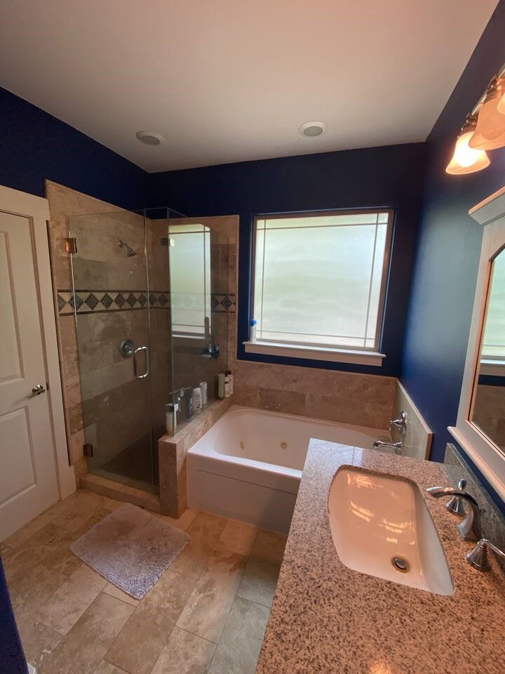 1007 Taulbee Lane, Unit A Austin, TX 78757 - Photo 12 of 17 a bathroom with a tub a sink and a large mirror