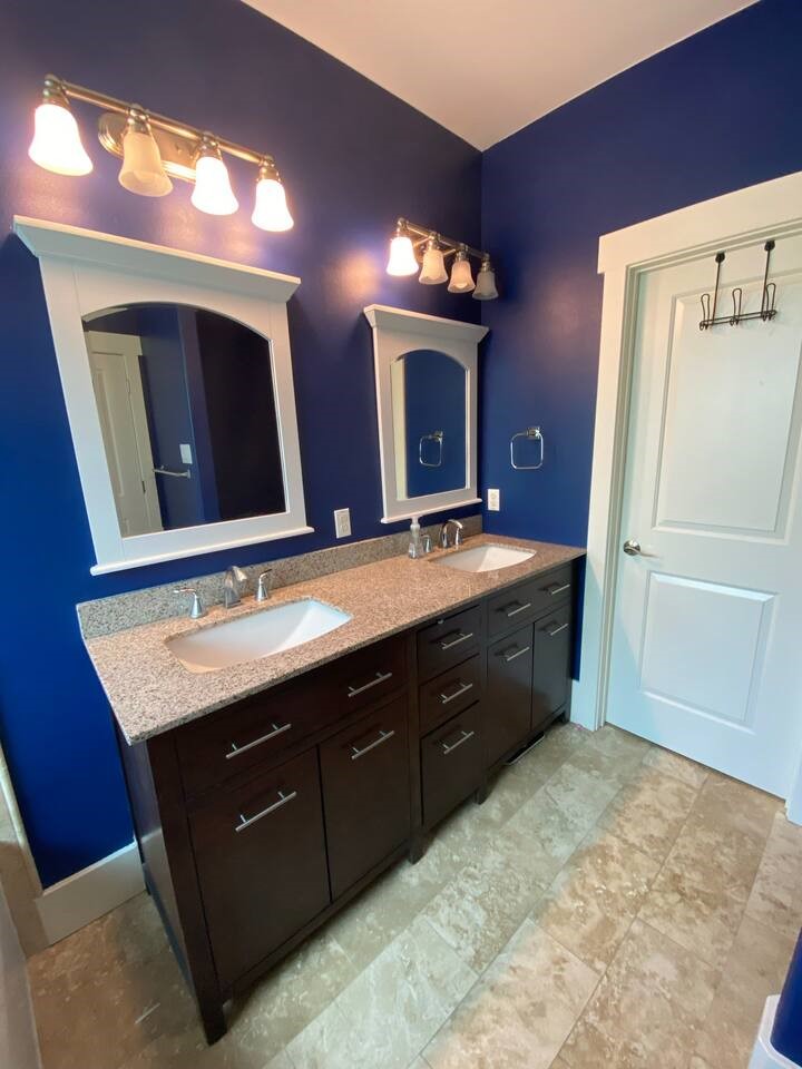 1007 Taulbee Lane, Unit A Austin, TX 78757 - Photo 13 of 17 a bathroom with a granite countertop double vanity sink and mirror