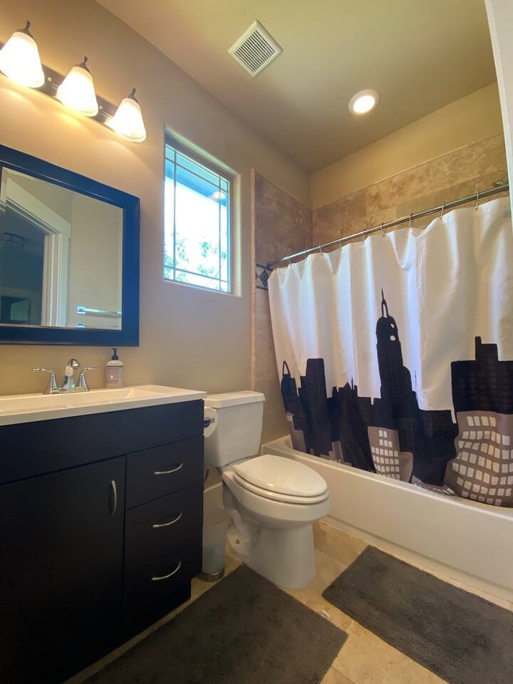 1007 Taulbee Lane, Unit A Austin, TX 78757 - Photo 15 of 17 a bathroom with a toilet sink and mirror