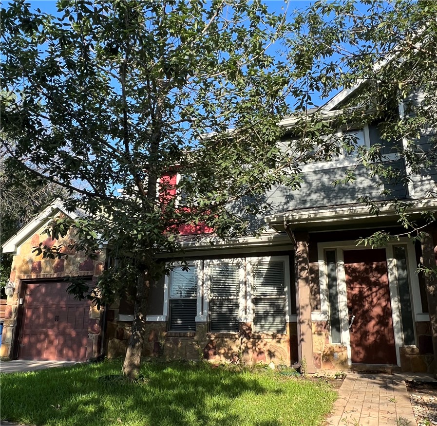 1007 Taulbee Lane, Unit A Austin, TX 78757 - Photo 2 of 17 a front view of a house with a tree