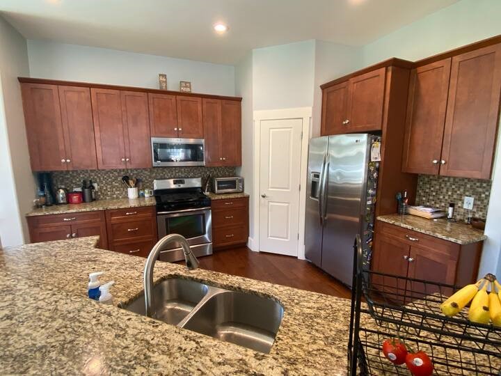 1007 Taulbee Lane, Unit A Austin, TX 78757 - Photo 7 of 17 a kitchen with granite countertop a refrigerator and a sink