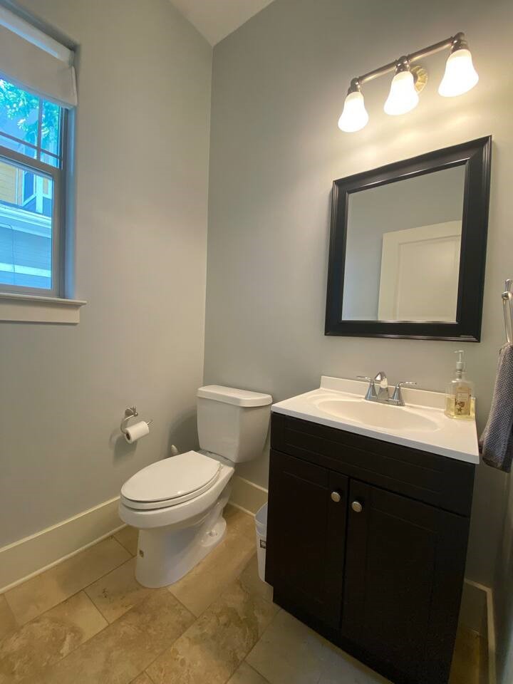 1007 Taulbee Lane, Unit A Austin, TX 78757 - Photo 9 of 17 a bathroom with a toilet sink and mirror