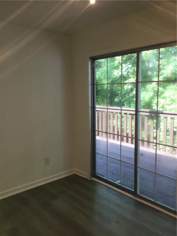 3186 Kingswood Glen Decatur, GA 30034 - Photo 7 of 23 an empty room with wooden floor and sliding door