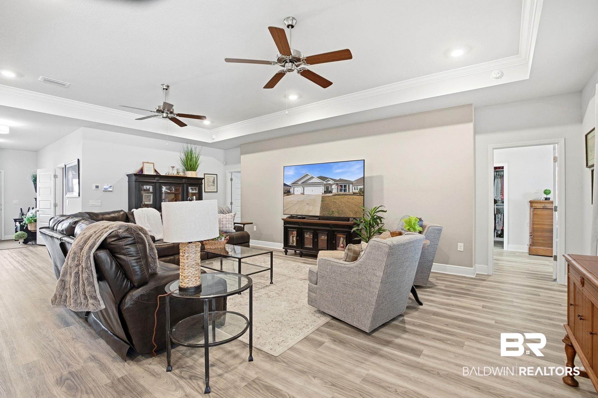 11123 Genuine Risk Circle Daphne, AL 36526 - Photo 11 of 67 Living area with a tray ceiling, crown molding, light wood-type flooring, ceiling fan, and recessed lighting