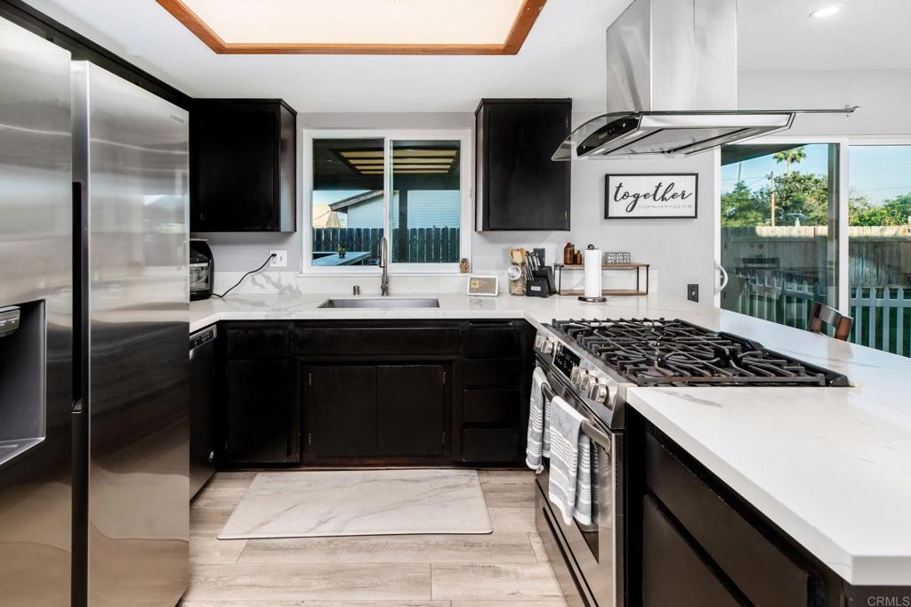 435 West Hawthorne Street Fallbrook, CA 92028 - Photo 13 of 42 a kitchen with a sink and a stove