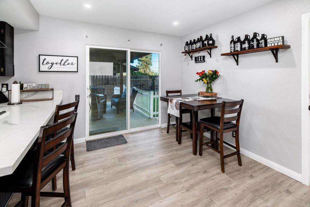 435 West Hawthorne Street Fallbrook, CA 92028 - Photo 15 of 42 a view of a dining room with furniture and wooden floor