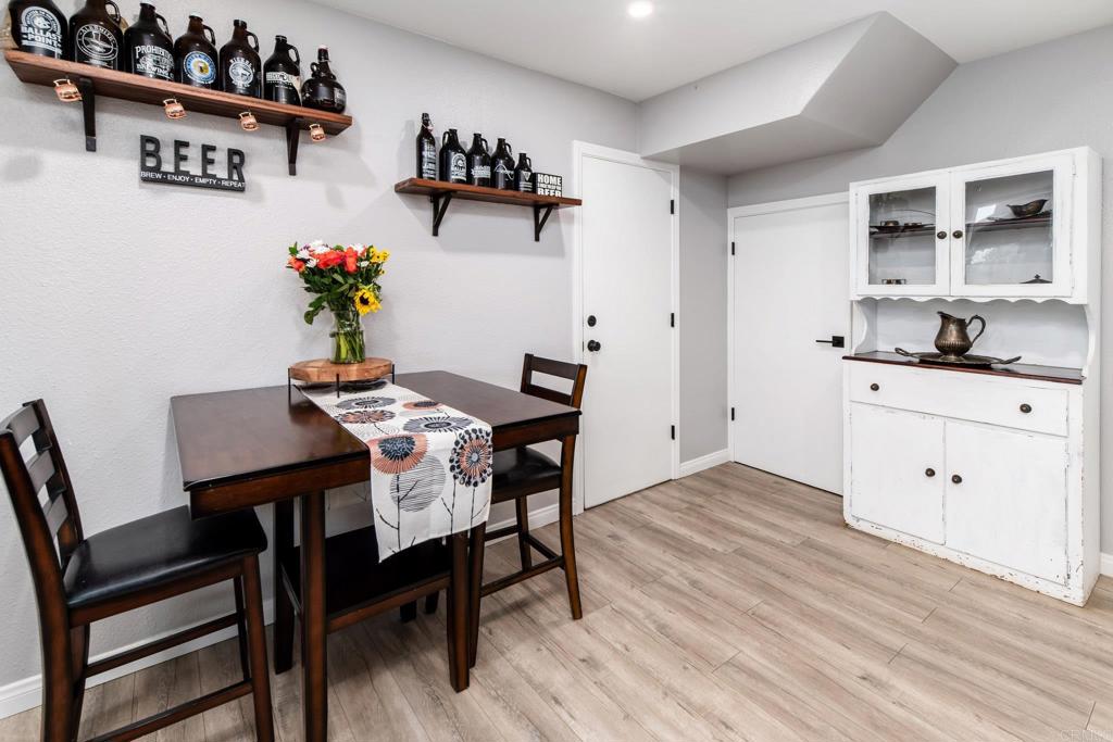 435 West Hawthorne Street Fallbrook, CA 92028 - Photo 16 of 42 a view of a dining room with furniture and wooden floor