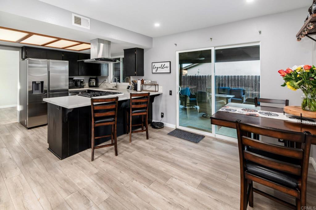 435 West Hawthorne Street Fallbrook, CA 92028 - Photo 17 of 42 a living room with furniture a fireplace and a flat screen tv