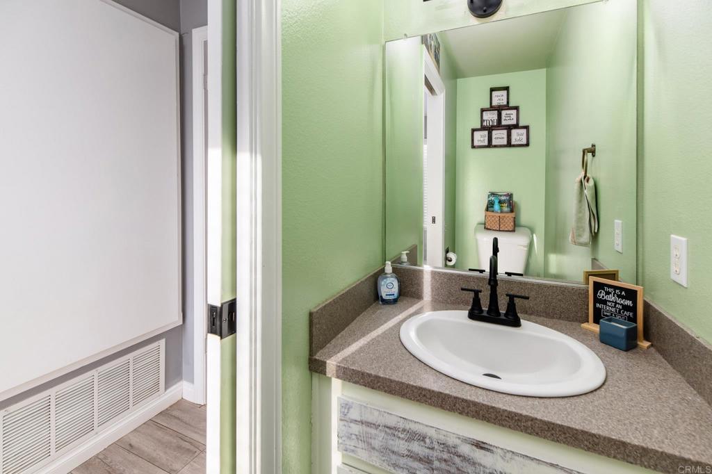435 West Hawthorne Street Fallbrook, CA 92028 - Photo 20 of 42 a bathroom with a sink a toilet and a mirror