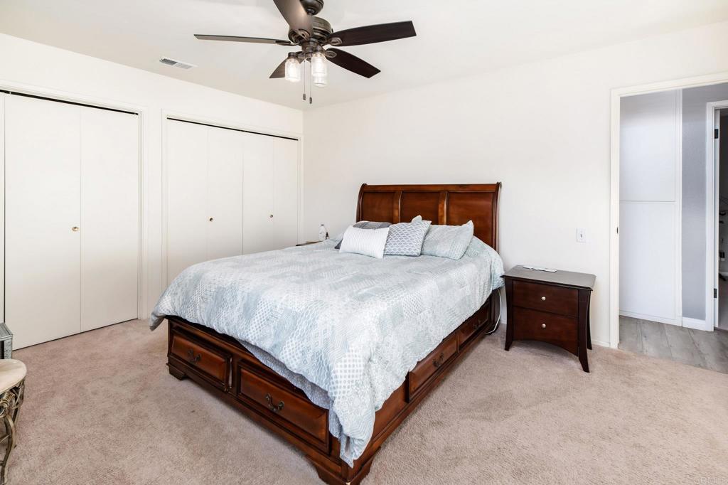 435 West Hawthorne Street Fallbrook, CA 92028 - Photo 23 of 42 a spacious bedroom with a bed and a dresser