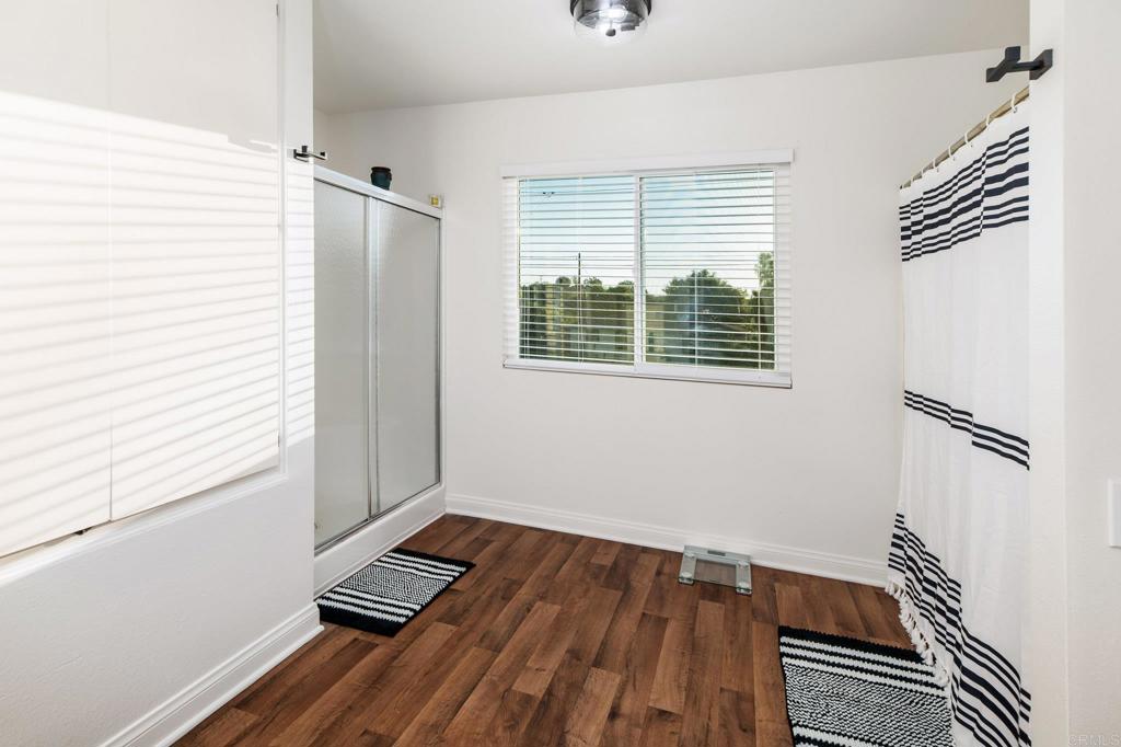 435 West Hawthorne Street Fallbrook, CA 92028 - Photo 25 of 42 a view of an empty room with a window and wooden floor