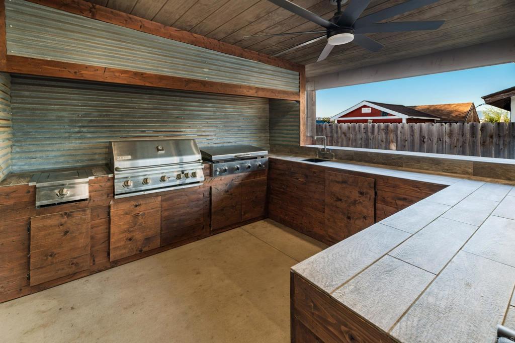 435 West Hawthorne Street Fallbrook, CA 92028 - Photo 28 of 42 a kitchen with stainless steel appliances granite countertop a stove a sink and a microwave