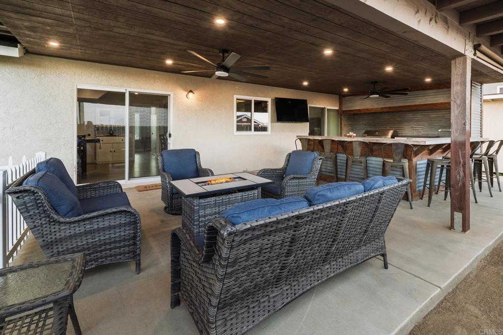 435 West Hawthorne Street Fallbrook, CA 92028 - Photo 33 of 42 a living room with furniture a flat screen tv and next to a window