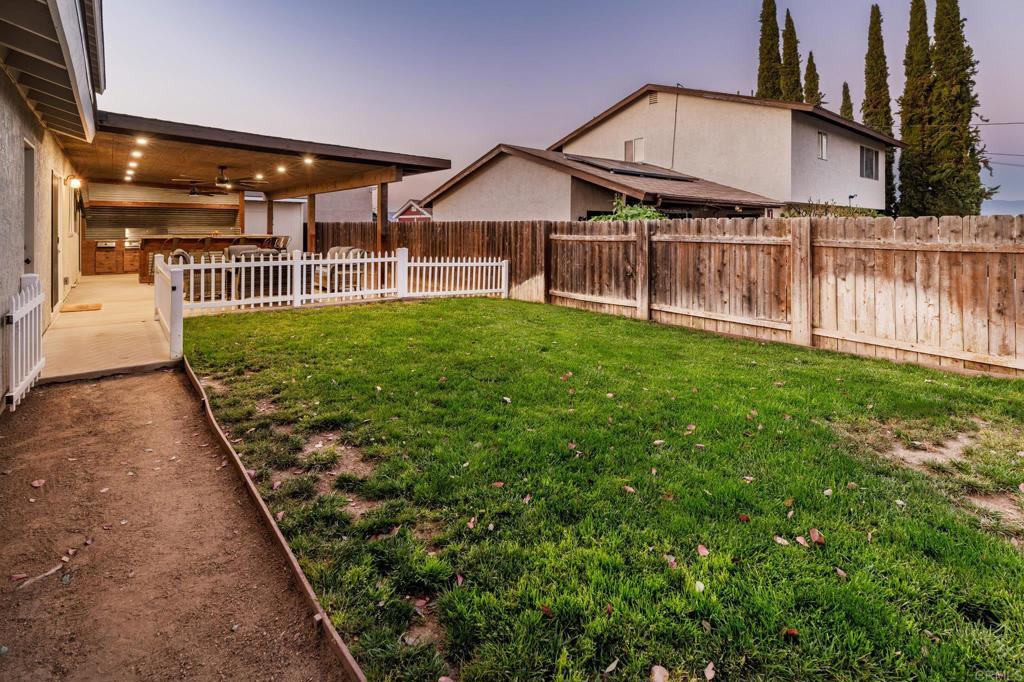 435 West Hawthorne Street Fallbrook, CA 92028 - Photo 37 of 42 a view of a house with a small yard and a garden